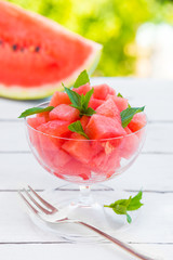 Cut watermelon in a glass bowl outdoors