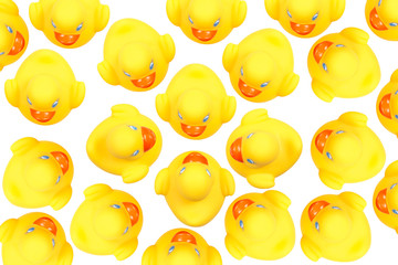 A lot yellow toy ducks with orange beaks seen from above while swimming, white background.  