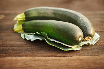 Fresh zucchini on a wooden table. Background