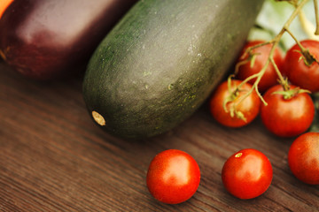 Fresh eggplant with tomato on a wooden table. Autumn concept.
