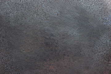 Black metal background, shiny iron texture close-up