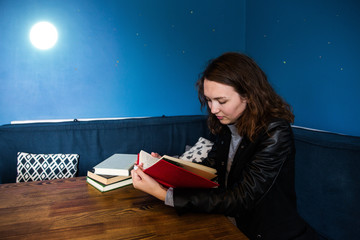 girl in jacket reading a book