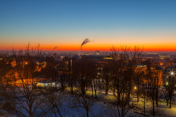 Obraz premium Exciting winter view of night old town of Tallinn. Aerial over park and industrial distrinct
