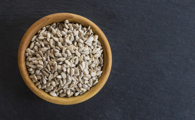 Peeled sunflower seeds on wooden table background, closeup