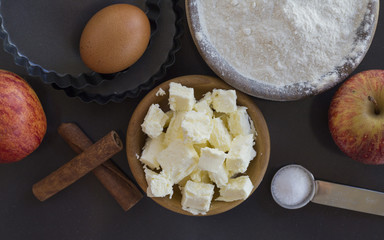flour and ingredients on black table. Top view
