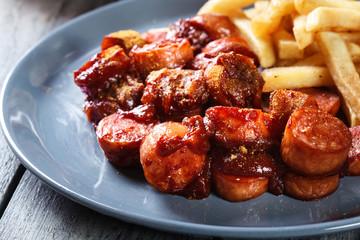 Traditional German currywurst - pieces of sausage with curry sauce