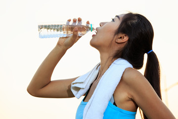 Women drinking water after exercise.