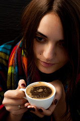 a young beautiful girl with hips on her shoulders holding a cup of coffee thoughtfully looking sideways, a cute portrait