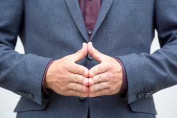 Close up hands of a male public speaker while giving a speech. 