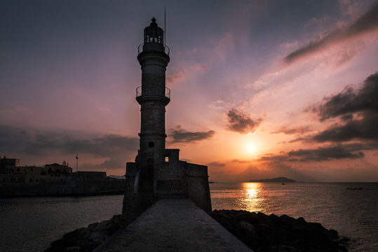 Sunset over the lighthouse and old Venetian harbour in Chania, Crete