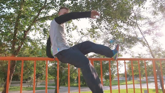 Young man doing parkour tricks in extreme sports park