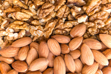Walnuts and almonds are located horizontally, background, texture
