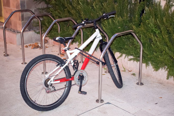 Fototapeta na wymiar Locked bicycle at bicycle parking