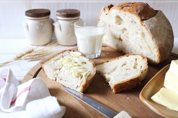 French sourdough bread, butter and glass of milk
