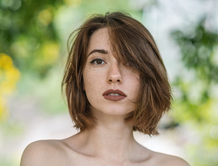 Portrait of beautiful sensual woman with freckles.