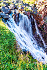 red rocks, waterfall, green grass, canyon, sunny day
