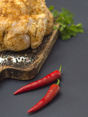 Marinated raw chicken on a kitchen table. 