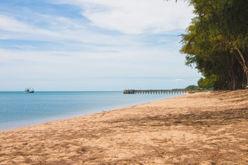 Fototapeta premium Sea landscape view on the beach with boat and jetty bridge