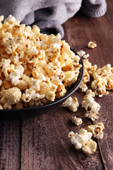 Salt popcorn or sweet popcorn in bowl on the wooden table