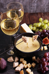 Gourmet Swiss fondue dinner on a winter evening with assorted ch