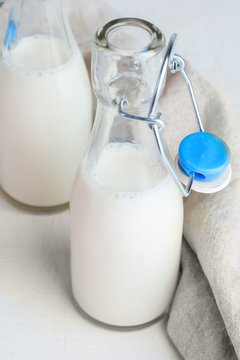 Milk in small glass bottles closeup.