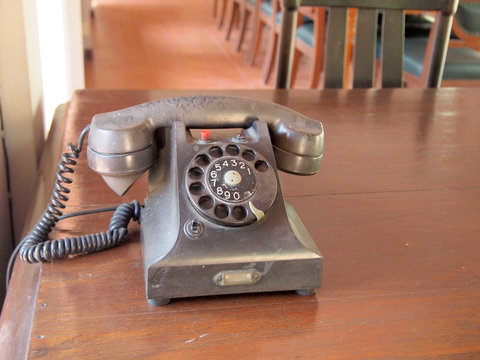 Retro black telephone on wooden table