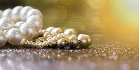 Website banner of beautiful white and golden pearls closeup