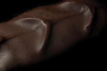 Texture of a chocolate bar close-up on a black background
