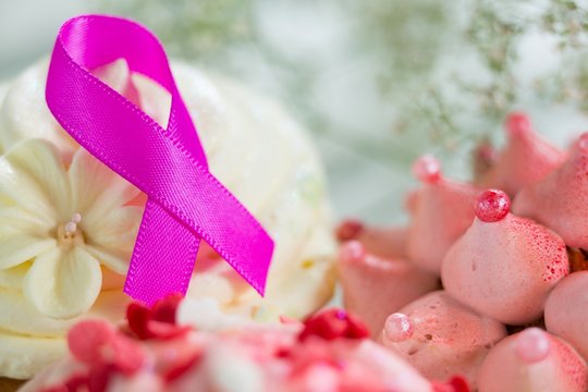 Close-up of pink Breast Cancer Awareness ribbon on cupcake
