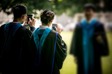 Selective focus of three graduates selfie, graduation and successful concept.