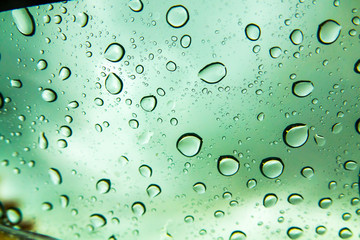 Raindrops on the window before the sunset. Rain drops on glass.