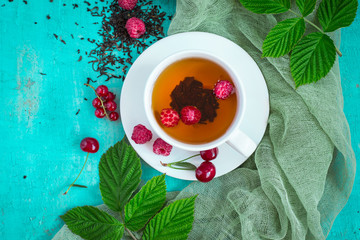 Freshly brewed tea with summer ripe berries. Top view with copy space