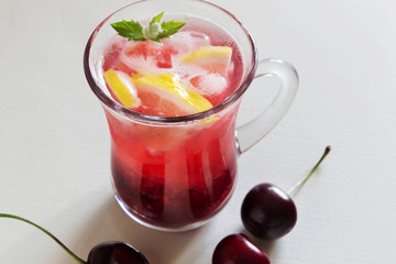 Homemade cherry lemonade on white table