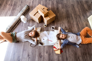 Young couple moving in new house, drinking coffee.