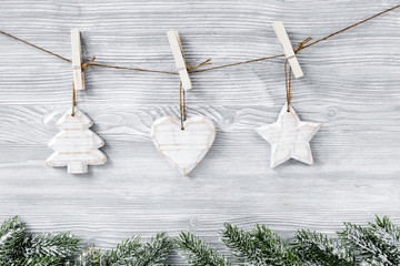 Christmas toys and spruce branches on wooden background top view