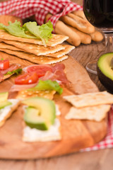 Crackers with ham and avocado. 