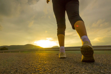 Woman running on road in the park.