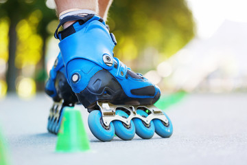 Inline roller skater on a slalom course