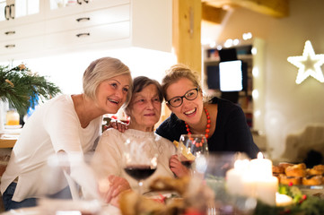Mother, grandmother and daughter celebrating Christmas.