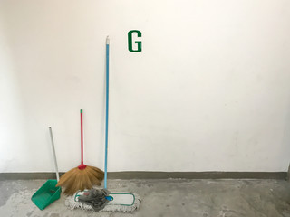 Cleaning equipment lean against the wall