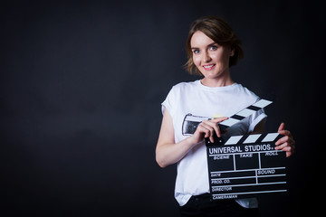 young woman holding a clapperboard cinema