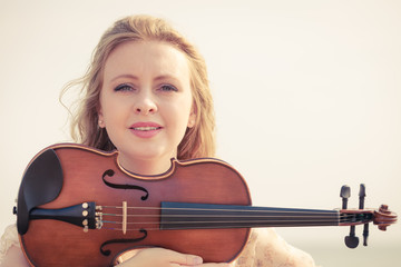 Musician violinist woman holding her violin