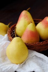 Juicy ripe yellow pears in a wooden table