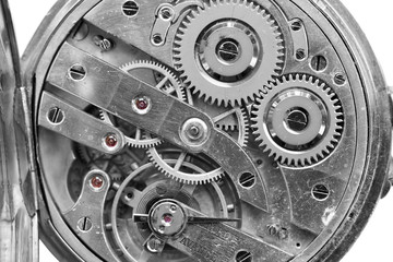 Silver Clockwork on white background. Detail of watch machinery. Old mechanical pocket watch. Macro shot.  