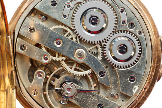 Golden Clockwork on white background. Detail of watch machinery. Old mechanical pocket watch. Macro shot.  