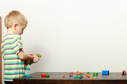 Little boy playing with toys having fun