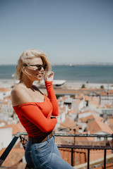 Blonde young Woman looking at the lisbon city landscape