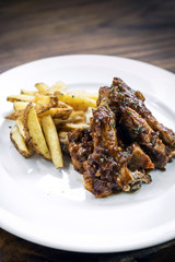 spicy bbq pork spare ribs with wedges french fries