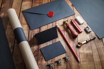 Photo of blank black stationery set on wood table background.. Template for branding identity. For...