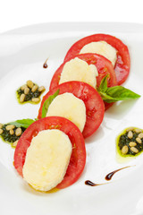 mozzarella with tomato and basil isolated on white